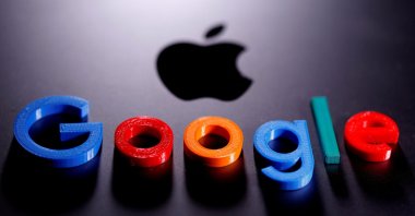 A 3D printed Google logo is placed on the Apple Macbook in this illustration taken April 12, 2020. (Reuters Photo)