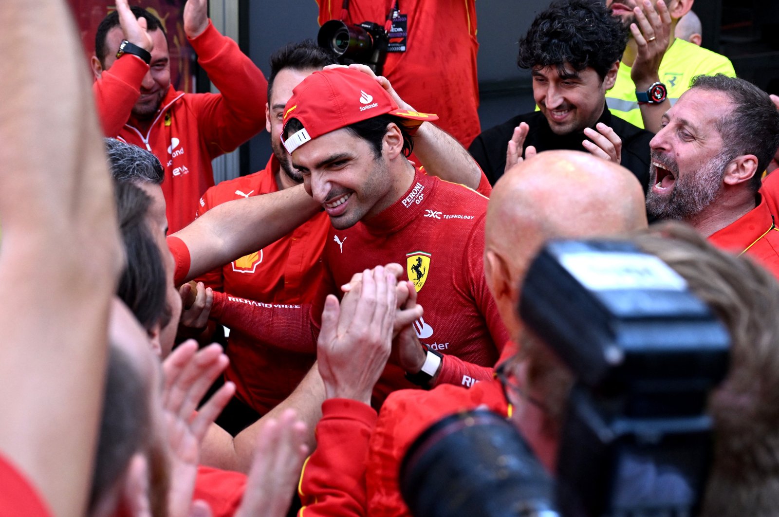 Ferrari&#039;s Carlos Sainz Jr. (C) celebrates winning the F1 Australian Grand Prix, Melbourne, Australia, March 24, 2024. (Reuters Photo)