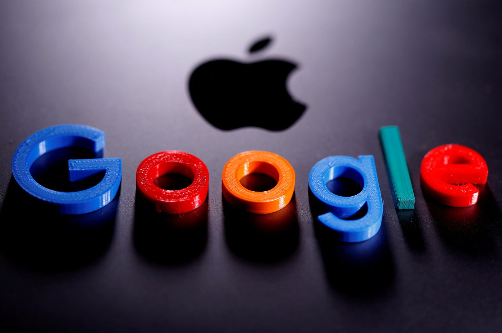 A 3D printed Google logo is placed on the Apple Macbook in this illustration taken April 12, 2020. (Reuters Photo)