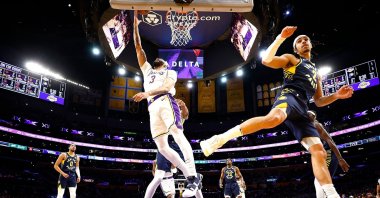 Los Angeles Lakers' Anthony Davis (L) takes a shot against Indiana Pacers' Andrew Nembhard in the first half at Crypto.com Arena, Los Angeles, U.S., March 24, 2024. (AFP Photo)