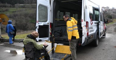 In the scope of the Samsun Municipality&#039;s &#039;Accessible Transportation Vehicle&#039; service, a healthcare worker assists a disabled citizen in boarding the vehicle, Samsun, Türkiye, Feb. 29, 2024. (IHA Photo)