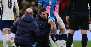 England's defender Kyle Walker (R) is treated by medical staff after picking up an injury during the international friendly football match between England and Brazil at Wembley Stadium, London, U.K., March 23, 2024. (AFP Photo)
