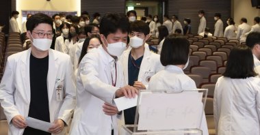 Medical professors line up to submit their resignations during a meeting at Korea University in Seoul, South Korea, March 25, 2024. (AP Photo)