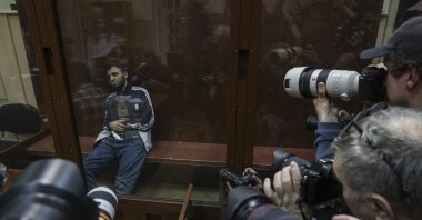 Photographers take pictures of a suspect in the terrorist attack on Crocus City Hall inside a defendant's enclosure at a pretrial hearing, Basmanny district court, Moscow, Russia, March 24, 2024. (EPA Photo)