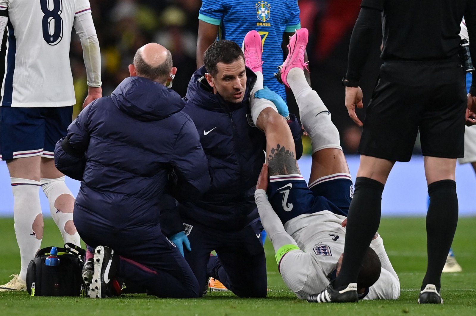England&#039;s defender Kyle Walker (R) is treated by medical staff after picking up an injury during the international friendly football match between England and Brazil at Wembley Stadium, London, U.K., March 23, 2024. (AFP Photo)