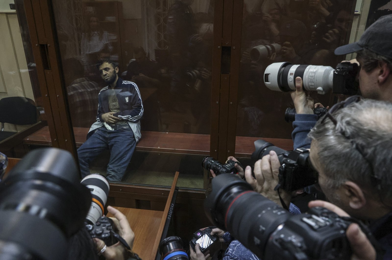 Photographers take pictures of a suspect in the terrorist attack on Crocus City Hall inside a defendant&#039;s enclosure at a pretrial hearing, Basmanny district court, Moscow, Russia, March 24, 2024. (EPA Photo)
