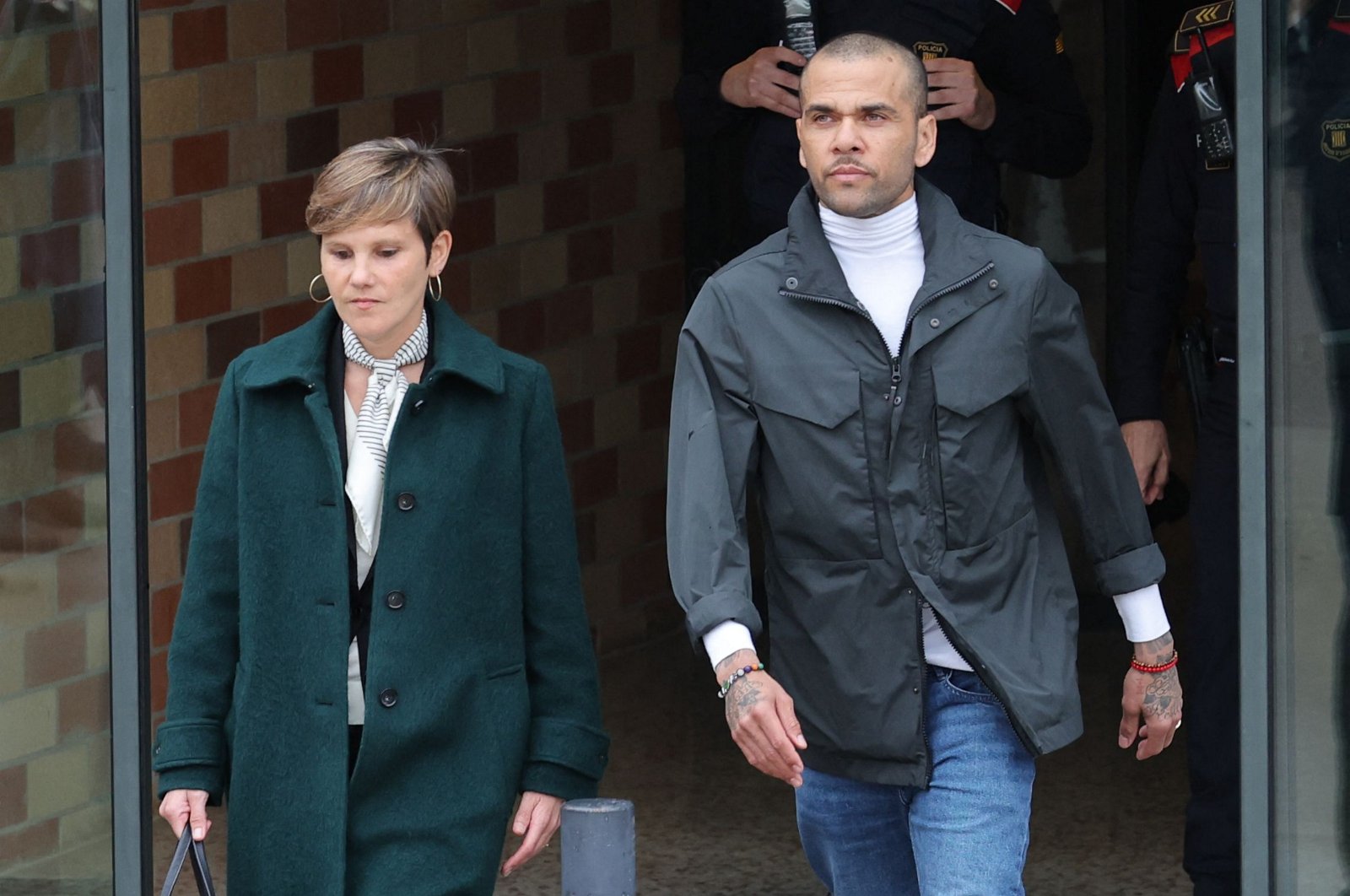 Former Brazil international football player Dani Alves (R) leaves on provisional release, flanked by his lawyer Ines Guardiola, Brians 2 Prison, Barcelona, Spain, March 25, 2024. (AFP Photo)