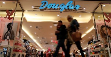 People pass in front of a Douglas Holding AG perfume shop at a shopping mall, Magdeburg, Germany, March 11, 2016. (Reuters Photo)