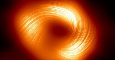 The polarized view of the Milky Way black hole, with lines marking the orientation of polarization related to the magnetic field around the shadow of the black hole, March 27, 2024. (The European Southern Observatory Handout via AFP)