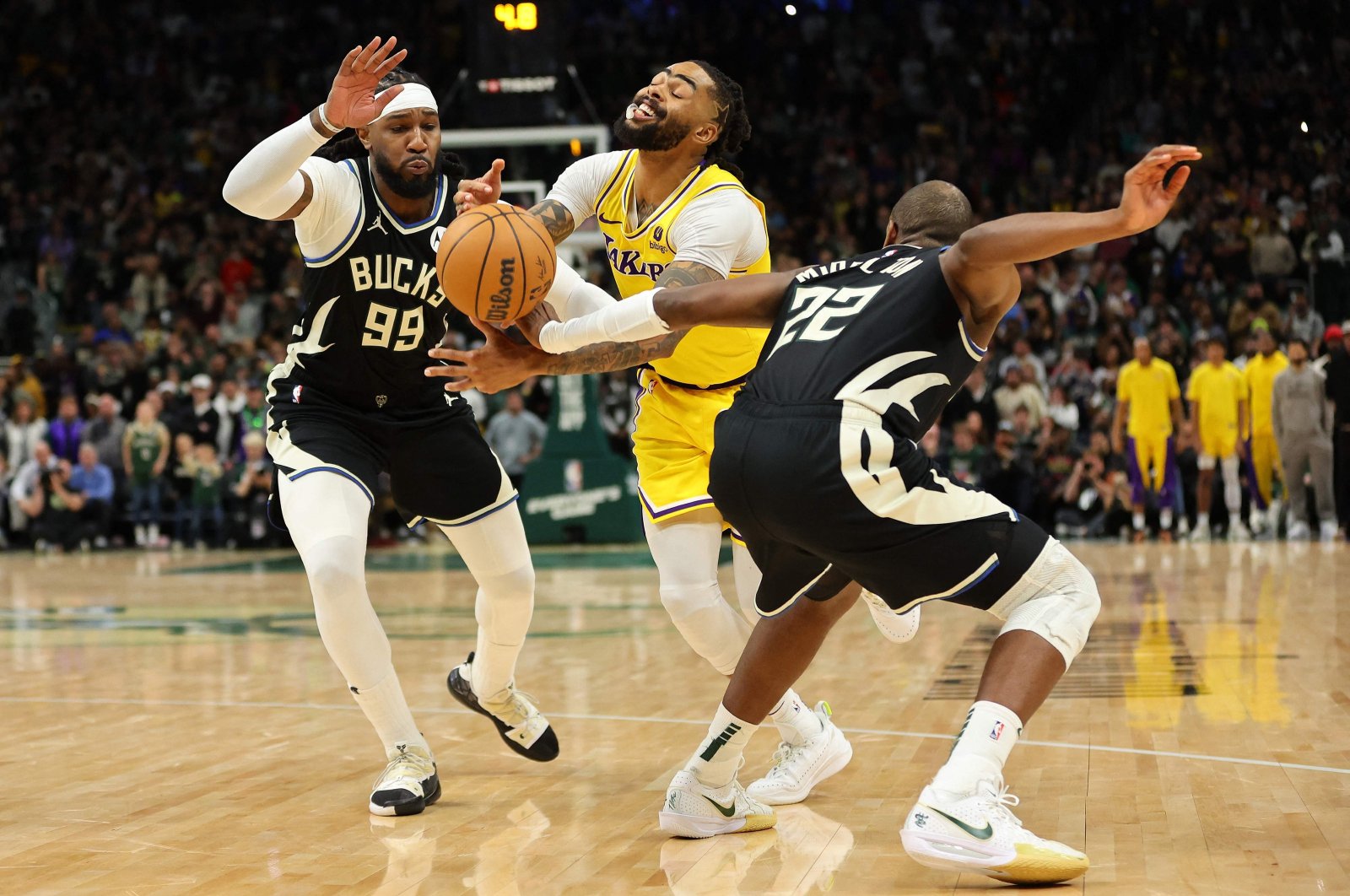 Los Angeles Lakers&#039; D&#039;Angelo Russell (C) is fouled by Milwaukee Bucks&#039; Khris Middleton (R) during overtime at Fiserv Forum, Milwaukee, U.S., March 26, 2024. (AFP Photo)