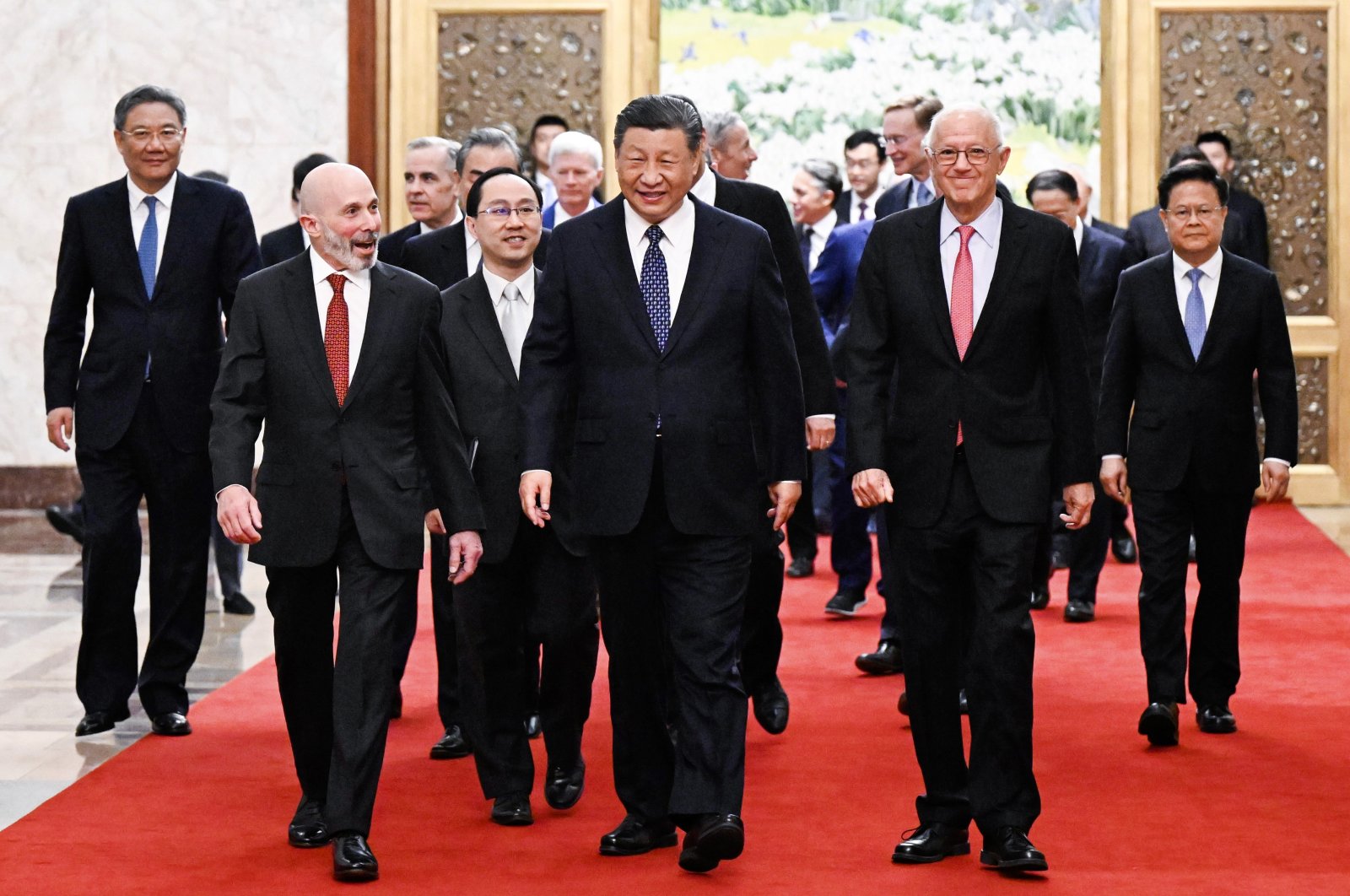 Chinese President Xi Jinping (C) walks with representatives from American business, strategic and academic communities at the Great Hall of the People in Beijing, China, March 27, 2024. (Xinhua via AP)