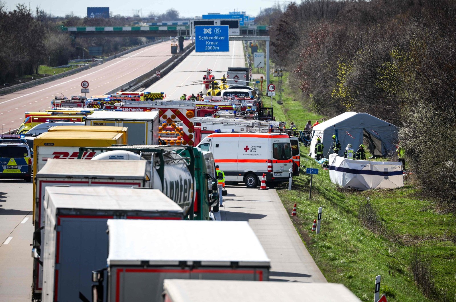 Emergency vehicles and rescue helicopters stand on the A9 highway at the scene of an accident, in Schkeuditz, near Leipzig, eastern Germany, March 27, 2024. (AFP Photo)