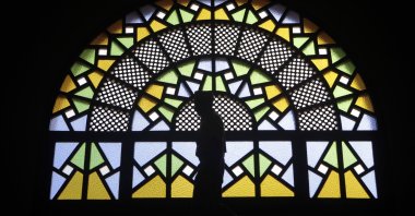 A man walks past stained glass windows inside the Gaddafi National mosque after Friday prayers in the capital of Kampala, Uganda, Oct. 21, 2011. (Reuters Photo)