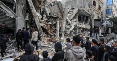 Palestinians gather to inspect the damage of a destroyed building belonging to the al-Gharib family, following Israeli attacks in Rafah, Gaza, Palestine, March 4, 2024. (AA Photo)