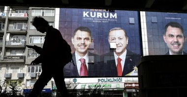 A person walks past images of President Recep Tayyip Erdoğan (C) and Justice and Development Party's (AK) Istanbul mayoral candidate Murat Kurum (L, R) as part of the campaign for the upcoming local elections in Istanbul, Türkiye, March 27, 2024. (EPA Photo)
