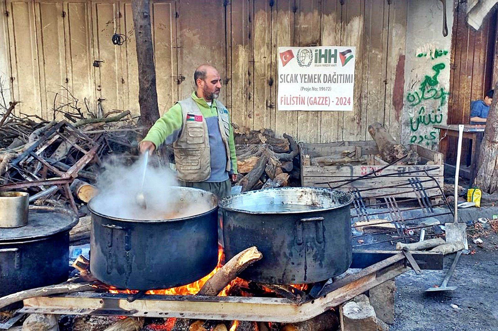 A Humanitarian Relief Foundation (IHH) worker cooks for Palestinians still suffering under Israeli bombardment, in Gaza, Palestine, March 18, 2024. (AA Photo)