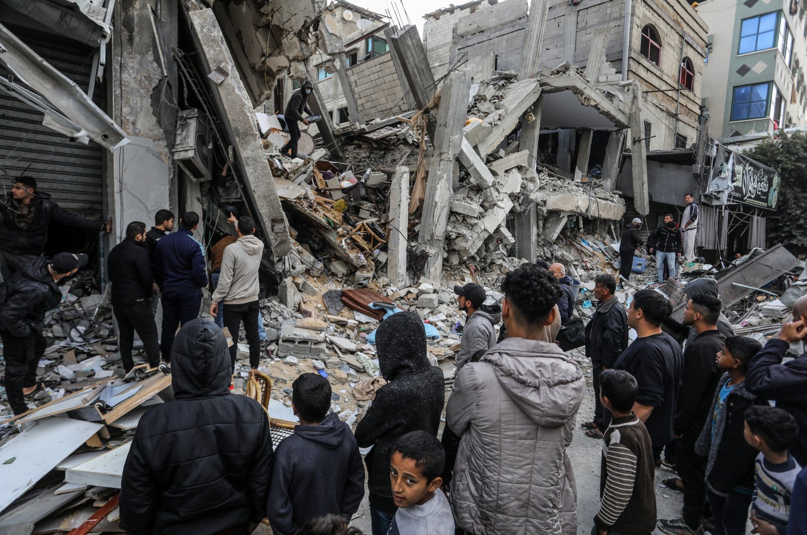Palestinians gather to inspect the damage of a destroyed building belonging to the al-Gharib family, following Israeli attacks in Rafah, Gaza, Palestine, March 4, 2024. (AA Photo)