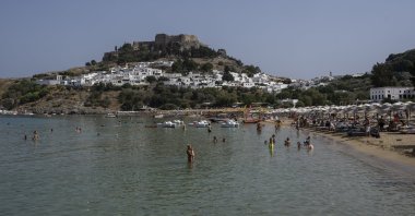 A view of the beach and the sea in Lindos, on the Aegean Sea island of Rhodes, southeastern Greece, July 27, 2023. (AP Photo)