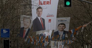 Election banners of Murat Kurum (R), mayoral candidate of the ruling AK Party, Istanbul's mayor Ekrem Imamoglu (C) and President Recep Tayyip Erdoğan hang along a street ahead of the local elections in Istanbul, Türkiye, March 28, 2024. (Reuters Photo)