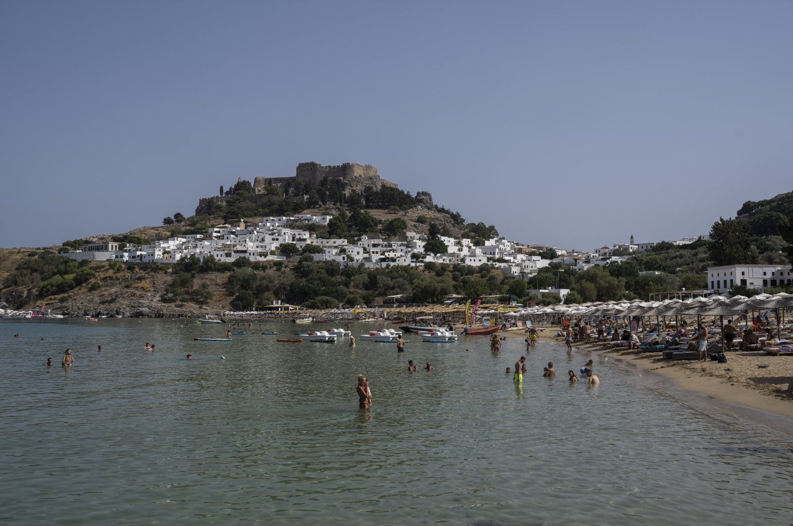 A view of the beach and the sea in Lindos, on the Aegean Sea island of Rhodes, southeastern Greece, July 27, 2023. (AP Photo)