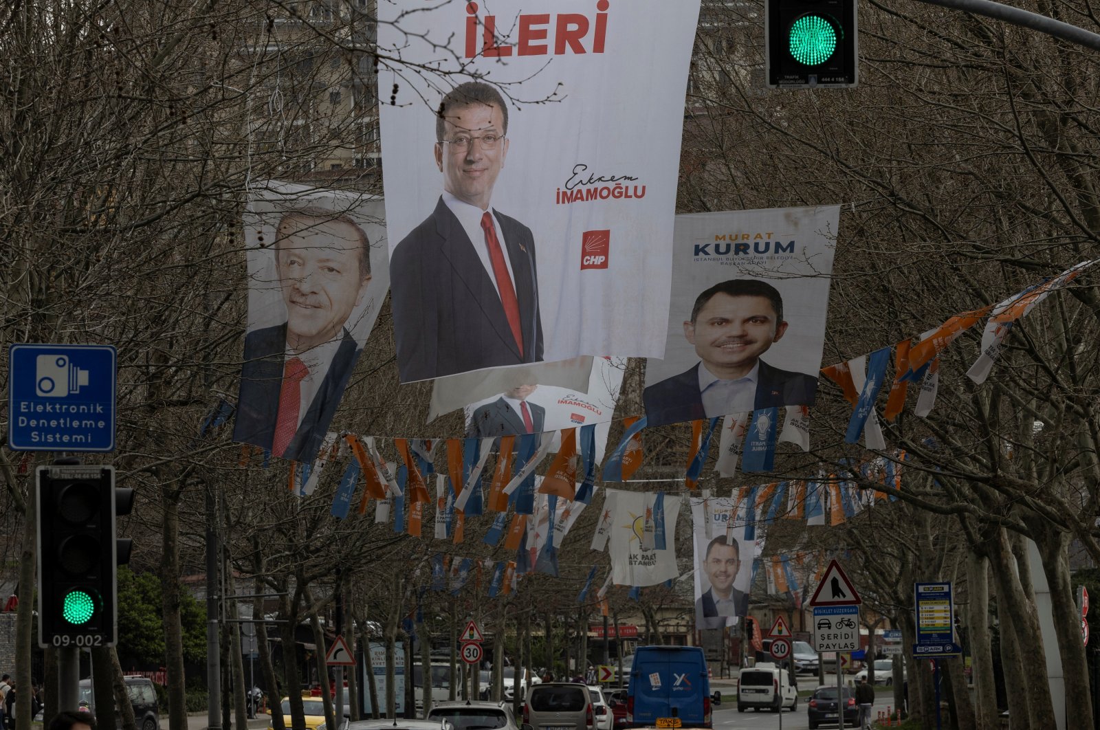 Election banners of Murat Kurum (R), mayoral candidate of the ruling AK Party, Istanbul&#039;s mayor Ekrem Imamoglu (C) and President Recep Tayyip Erdoğan hang along a street ahead of the local elections in Istanbul, Türkiye, March 28, 2024. (Reuters Photo)