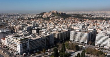 The ancient Parthenon temple on the top of Acropolis Hill in the background and residential complexes in front, Athens, Greece, March 30, 2024. (AFP Photo)