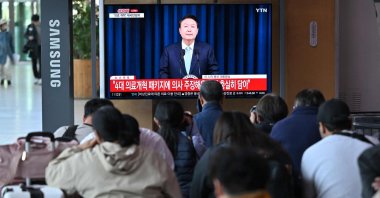 People watch a television news program broadcasting live footage of South Korean President Yoon Suk Yeol delivering a speech on his medical reform plans at a railway station in Seoul, South Korea, April 1, 2024. (AFP Photo)