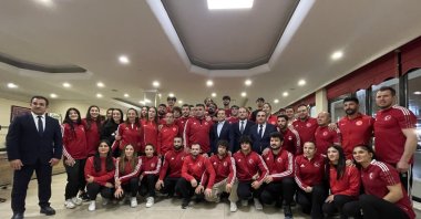Turkish Wrestling Federation President Şeref Eroğlu (C) stands with the Turkish wrestling team at the Mersinli Ahmet Training Complex Sports Facilities, Istanbul, Türkiye, March 28, 2024. (IHA Photo)