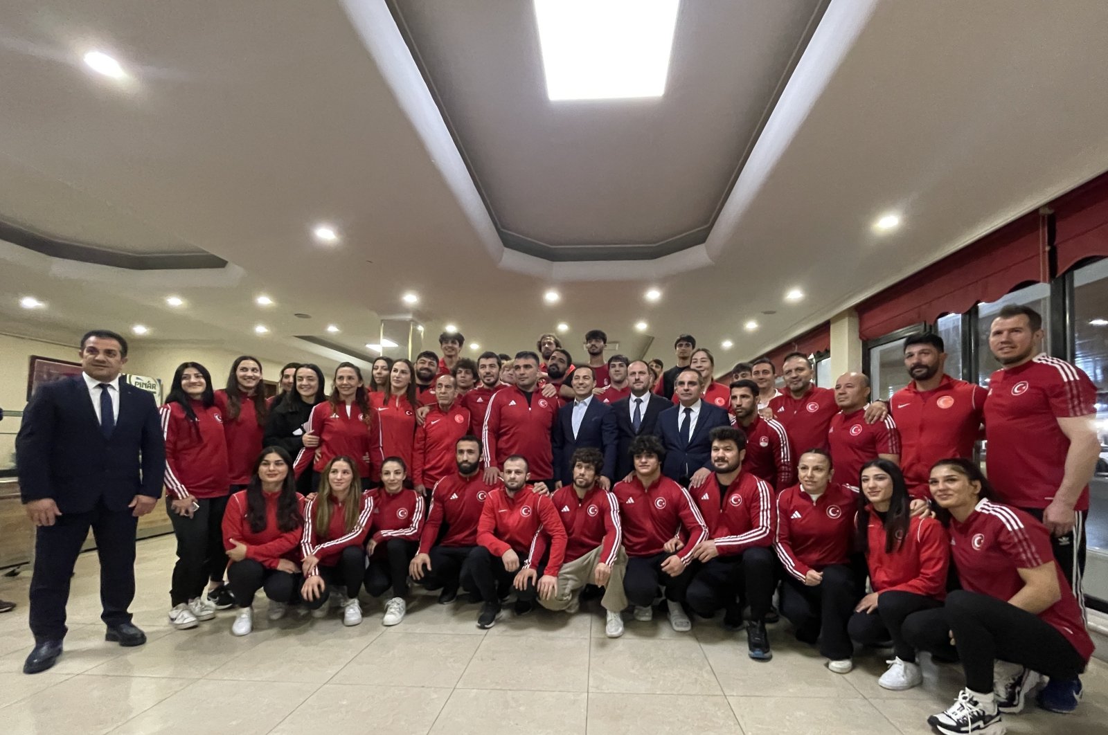 Turkish Wrestling Federation President Şeref Eroğlu (C) stands with the Turkish wrestling team at the Mersinli Ahmet Training Complex Sports Facilities, Istanbul, Türkiye, March 28, 2024. (IHA Photo)