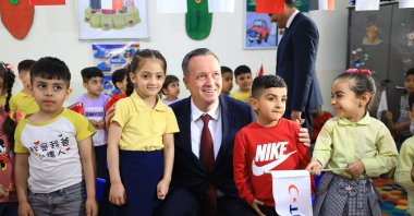 TIKA President Serdar Kayalar poses with kids during the inauguration of the Şakaik Kindergarten renovated by the Turkish Cooperation and Coordination Agency (TIKA), Baghdad, Iraq, April 2, 2024. (AA Photo)