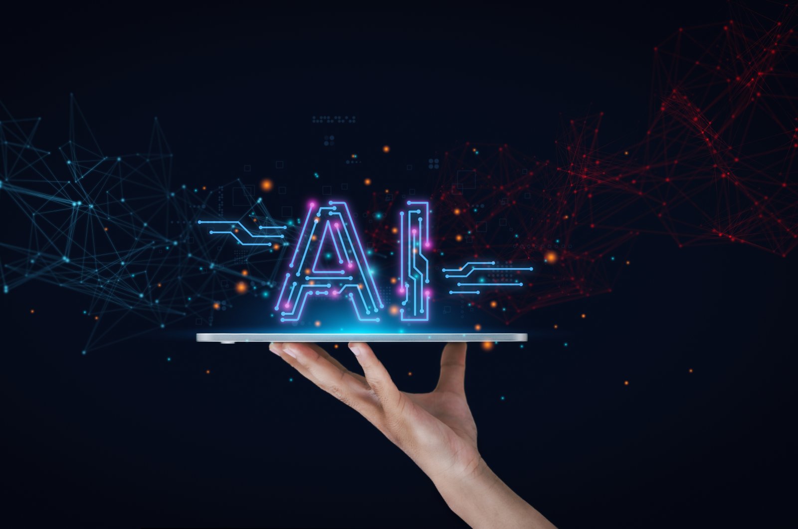 AI signage is written over a screen being held up by a hand. (Shutterstock Photo)