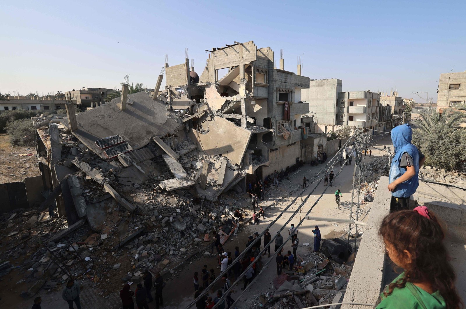 Young Palestinians stand on a rooftoop overlooking the destruction in Rafah following overnight Israeli bombardment of the area, in the southern Gaza Strip, Palestine, April 2, 2024. (AFP Photo)