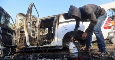 A Palestinian inspects near a vehicle where employees from the World Central Kitchen (WCK), including foreigners, were killed in an Israeli airstrike, in Deir al-Balah, central Gaza, Palesitne, April 2, 2024. (Reuters Photo)