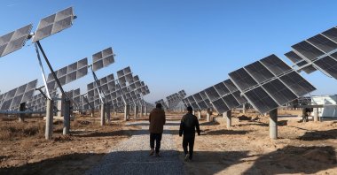 Workers walk at a solar power station in Tongchuan, Shaanxi province, China, Dec. 11, 2019. (Reuters Photo)