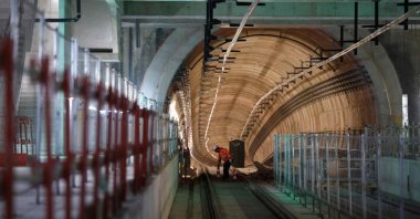 A worker places worksite cones in the metro tunnel prior to the last welding of the rails on the 15 South metro line of the new "Grand Paris Express", in the railway station of Clamart on April 3, 2024. (AFP Photo)