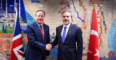 Foreign Minister Hakan Fidan and British counterpart David Cameron shake hands in Brussels, April 3, 2024. (IHA Photo)