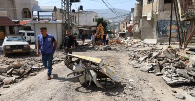 A man walks past rubble after an overnight Israeli raid at Al-Farea refugee camp, near the occupied West Bank city of Tubas, Palestine, April 3, 2024. (EPA Photo)