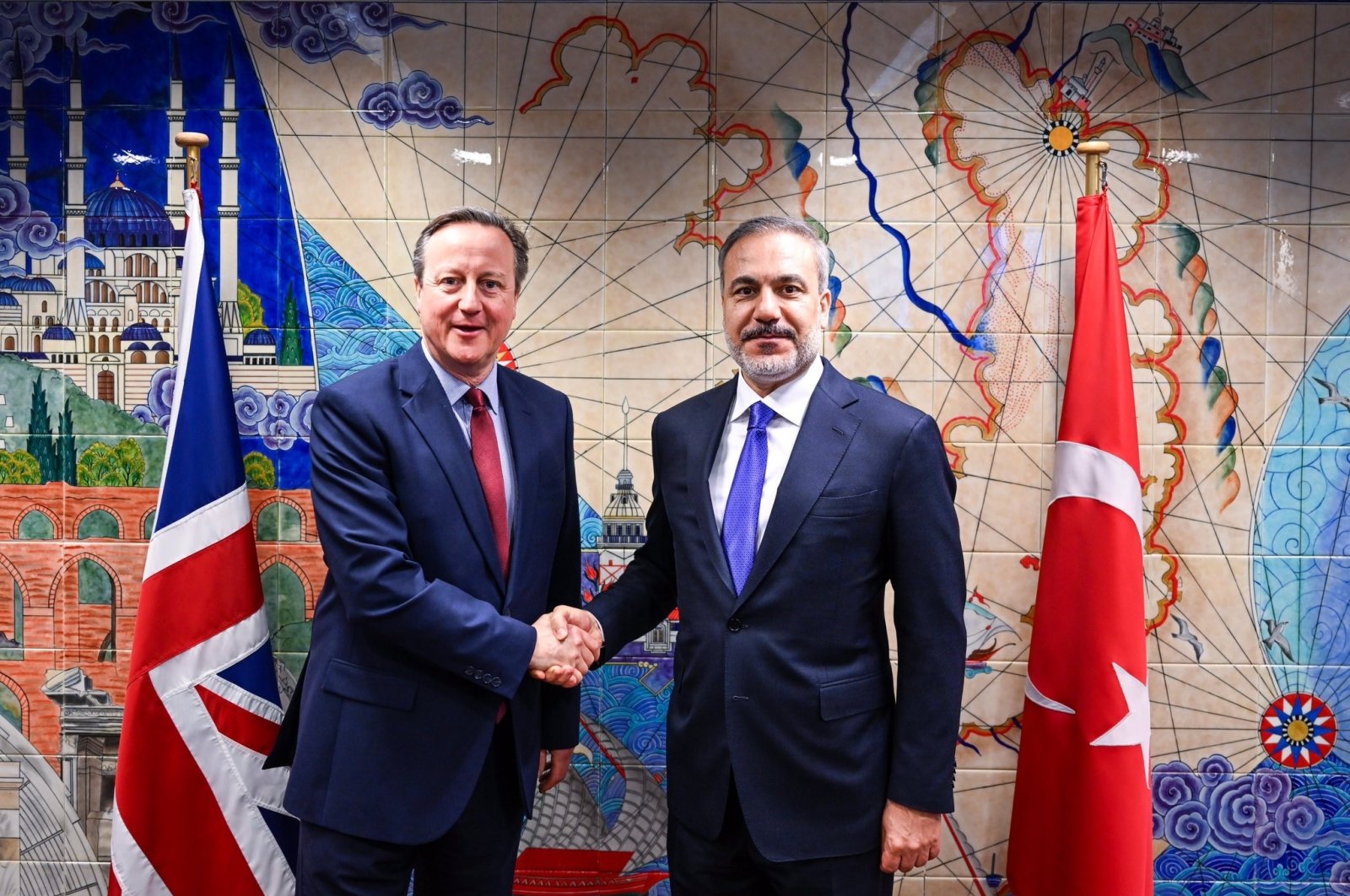 Foreign Minister Hakan Fidan and British counterpart David Cameron shake hands in Brussels, April 3, 2024. (IHA Photo)