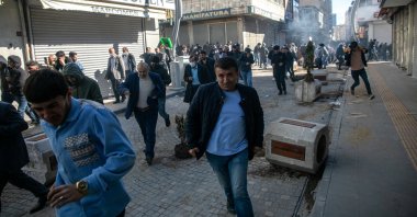 People run after clashes with security forces during a protest against the decision to revoke the mandate of newly elected opposition party mayor Abdullah Zeydan, Van, eastern Türkiye, April 3, 2024.