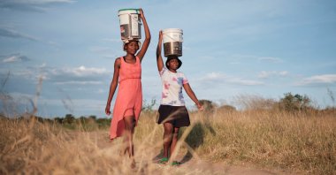 Residents of Pumula East township walk home after fetching water from a well, as temperatures soar during an El Nino-related heatwave and drought, Bulawayo, Zimbabwe, March 7, 2024. (Reuters Photo)
