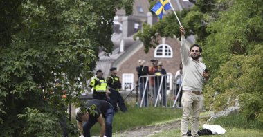 Agitator Salwan Momika waves the Swedish flag outside the Iraqi Embassy in Stockholm, Sweden, July 20, 2023. (AP File Photo)