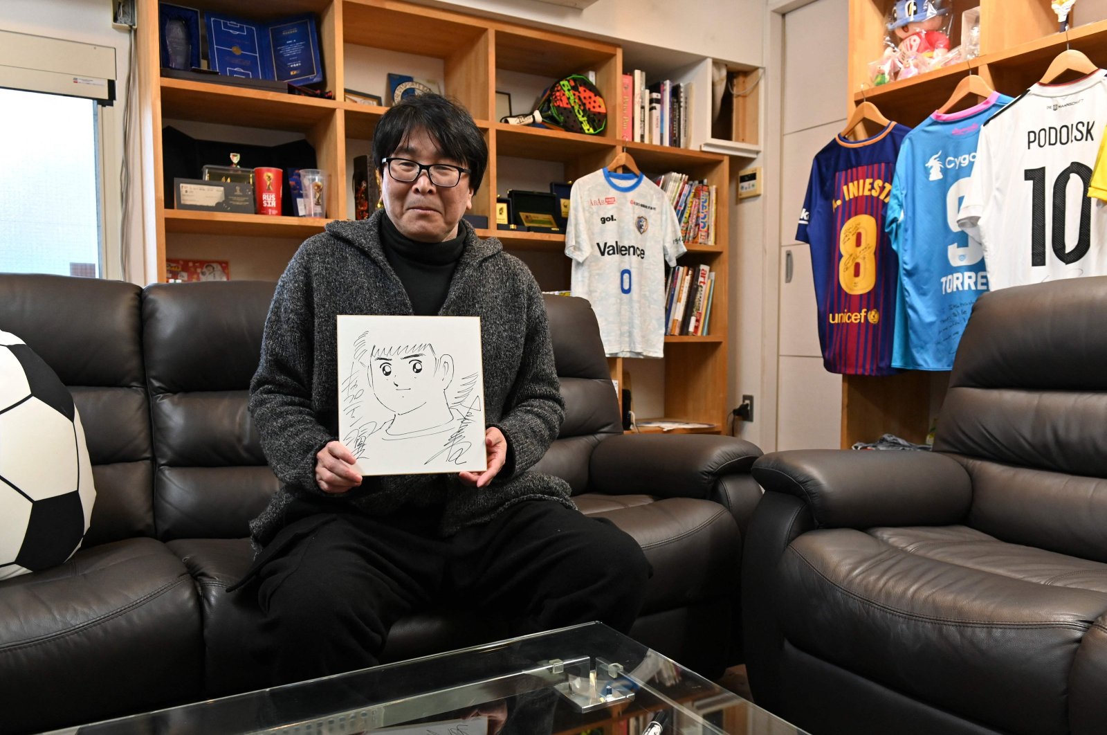 Japanese cartoonist and manga artist Yoichi Takahashi, best known for his work &quot;Captain Tsubasa,&quot; displays his autograph with the painting of the main character following an interview at his workplace in Tokyo, Japan, Jan. 30, 2023. (AFP Photo)