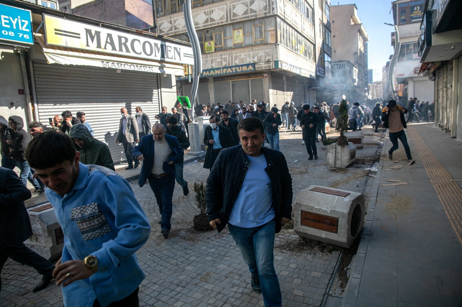 People run after clashes with security forces during a protest against the decision to revoke the mandate of newly elected opposition party mayor Abdullah Zeydan, Van, eastern Türkiye, April 3, 2024.