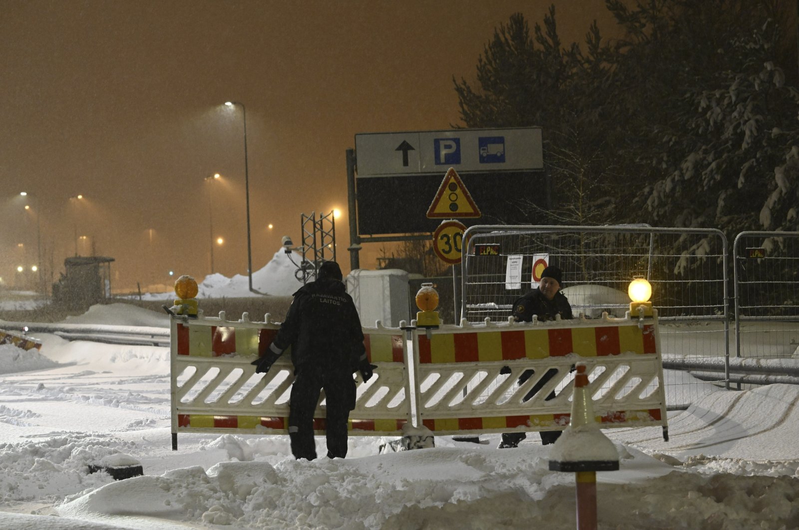 A Finnish border guard removes fences at the closed Vaalimaa border checkpoint between Finland and Russia, Virolahti, Finland, Dec. 13, 2023. (AP File Photo)