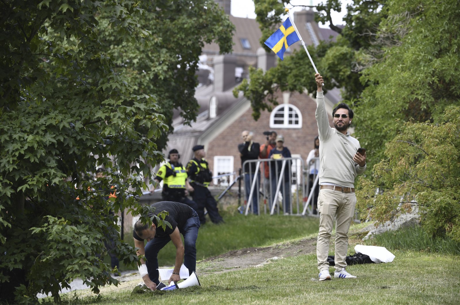 Agitator Salwan Momika waves the Swedish flag outside the Iraqi Embassy in Stockholm, Sweden, July 20, 2023. (AP File Photo)