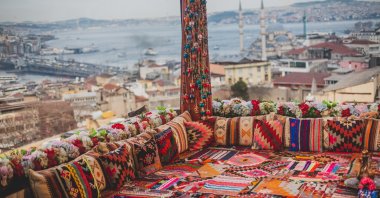 Istanbul from a high terrace decorated with traditional colorful ornamental pillows. (Shutterstock Photo)