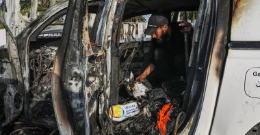 A man examines the interior of a destroyed car of the NGO World Central Kitchen (WCK) along al-Rashid road, between Deir al-Balah and Khan Younis, Gaza Strip, Palestine, April 2, 2024. (EPA Photo)