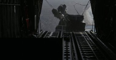 A U.S. Air Force C-130J Super Hercules conducting an airdrop of humanitarian assistance over Gaza, Palestine, March. 7, 2024. (CENTCOM Handout via AFP Photo)