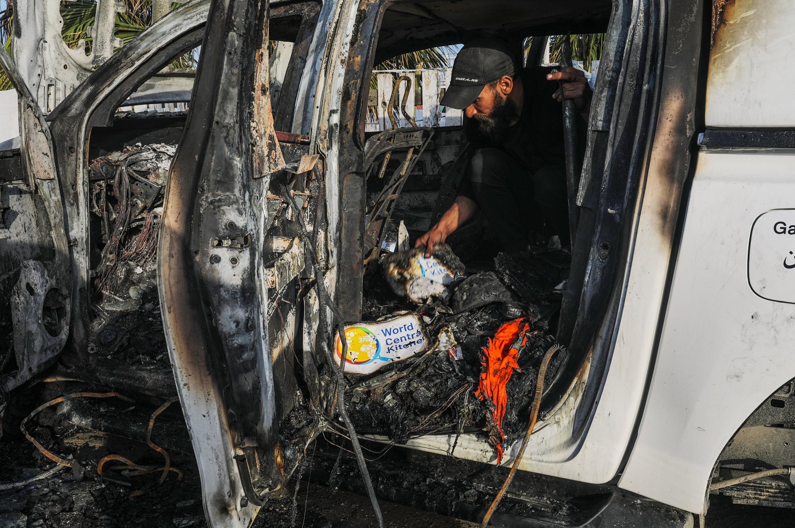 A man examines the interior of a destroyed car of the NGO World Central Kitchen (WCK) along al-Rashid road, between Deir al-Balah and Khan Younis, Gaza Strip, Palestine, April 2, 2024. (EPA Photo)