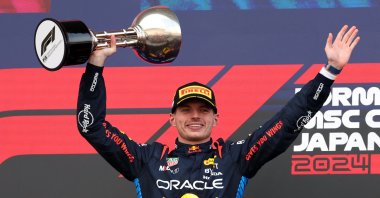 Red Bull&#039;s Max Verstappen celebrates with a trophy on the podium after winning the Japanese Grand Prix, Suzuka, Japan, April 7, 2024. (Reuters Photo)
